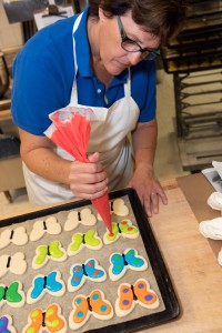 Baker colouring sugar cookies