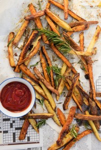 potato fries with rosemary laid out on paper
