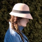 woman wearing jean jacket and hat