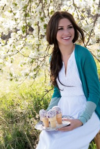 woman with three Raspberry Mango Gelato cones on a serving tray, on her lap