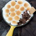 marshmallows s'more on cast iron pan on camping blanket