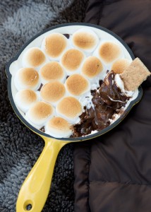 marshmallows s'more on cast iron pan on camping blanket