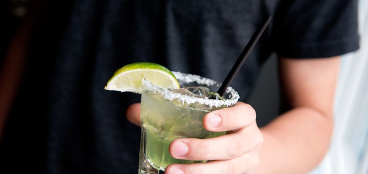Margarita glass, with salt rim and lime