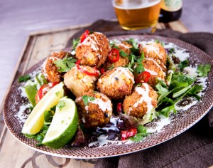 couscous & corn croquettes on bed of lettuce with lime