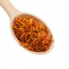 saffron spice in wooden spoon isolation white background