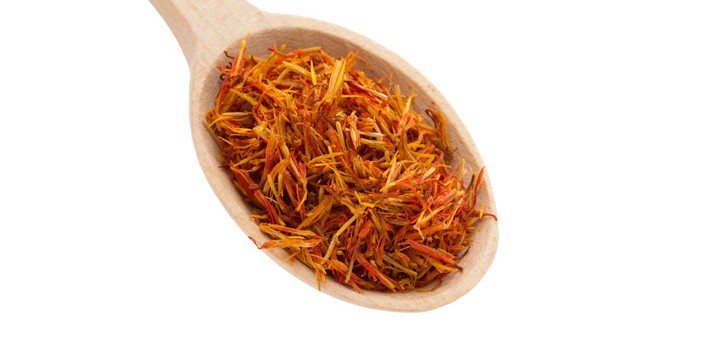 saffron spice in wooden spoon isolation white background