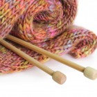 Knitting needles with finished garment