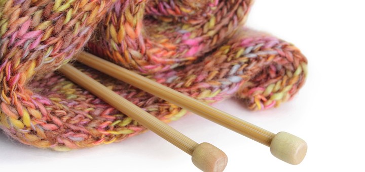 Knitting needles with finished garment