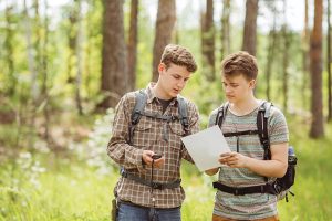 two young tourist determine the route map and navigator